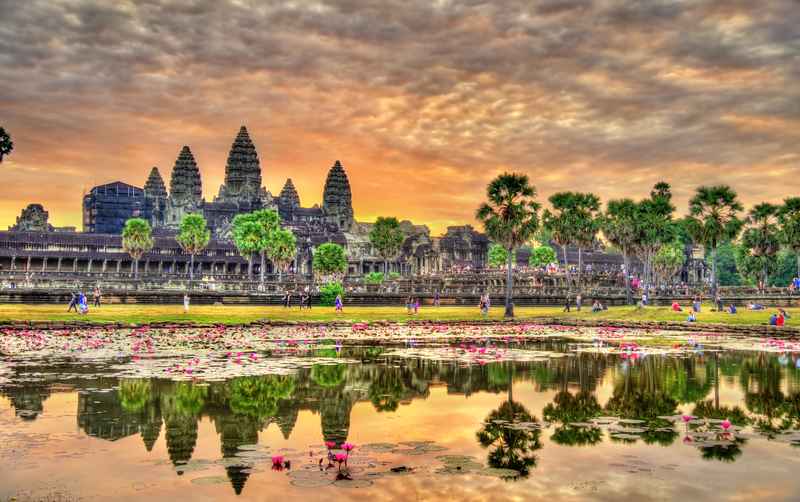 Angkor Wat temple at sunrise with reflection in Siem Reap Cambodia