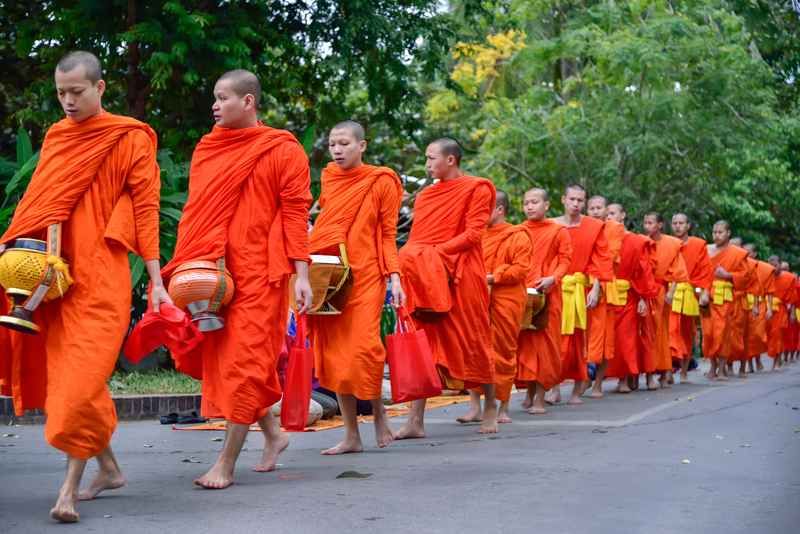 Morning alms giving ceremony with monks in Luang Prabang Laos